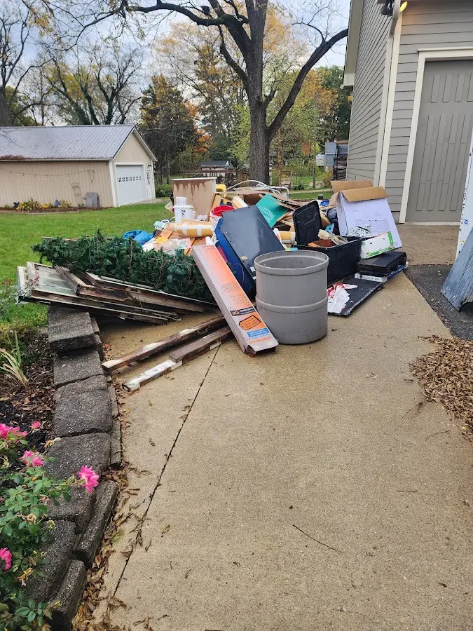 Dumpster being loaded with debris for 12 Yard Dumpster Rental in Forest Grove